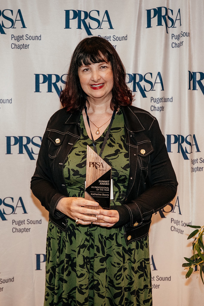 Katherine Boury at the 2026 Summit Awards posing for a photo in front of a backdrop.